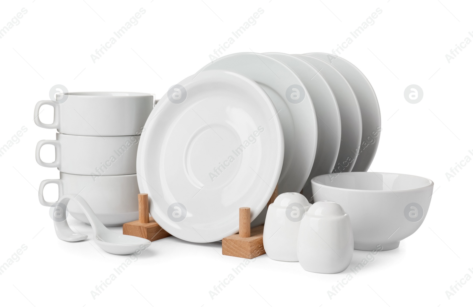 Photo of Set of clean dishware isolated on white