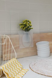 Silicone vase with flowers on countertop in kitchen