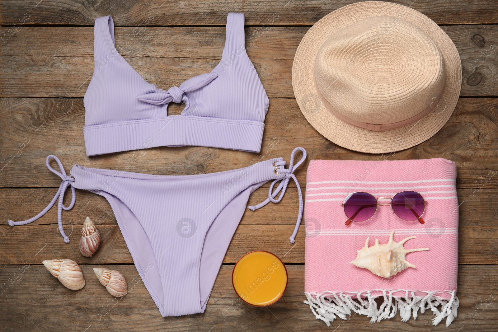 Photo of Flat lay composition with beach accessories on wooden background