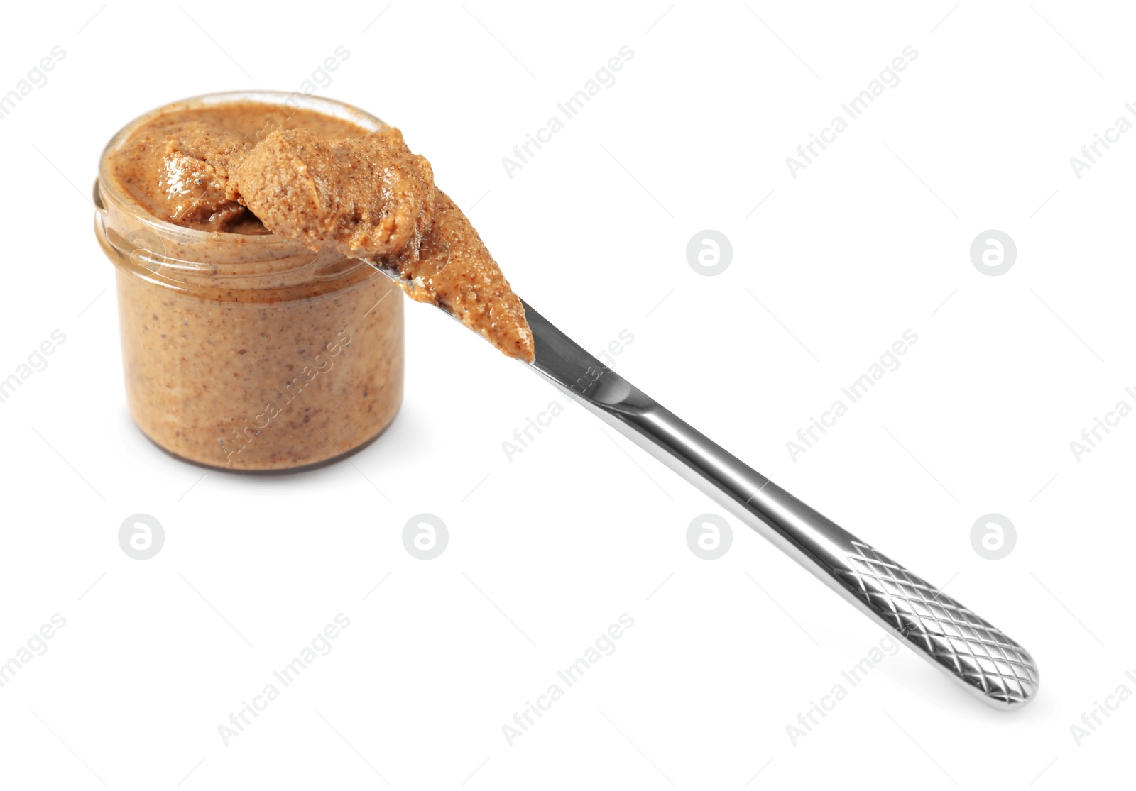 Photo of Delicious nut butter in jar and knife isolated on white