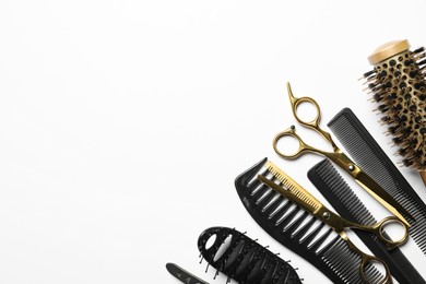 Photo of Hairdressing tools on white background, flat lay. Space for text