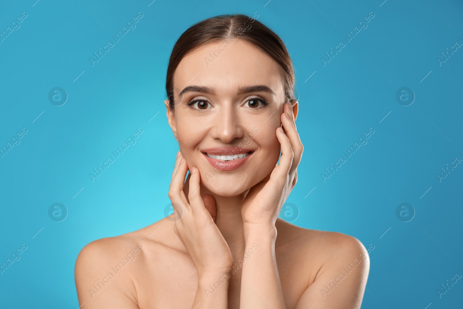 Photo of Beautiful woman with perfect smooth skin on light blue background