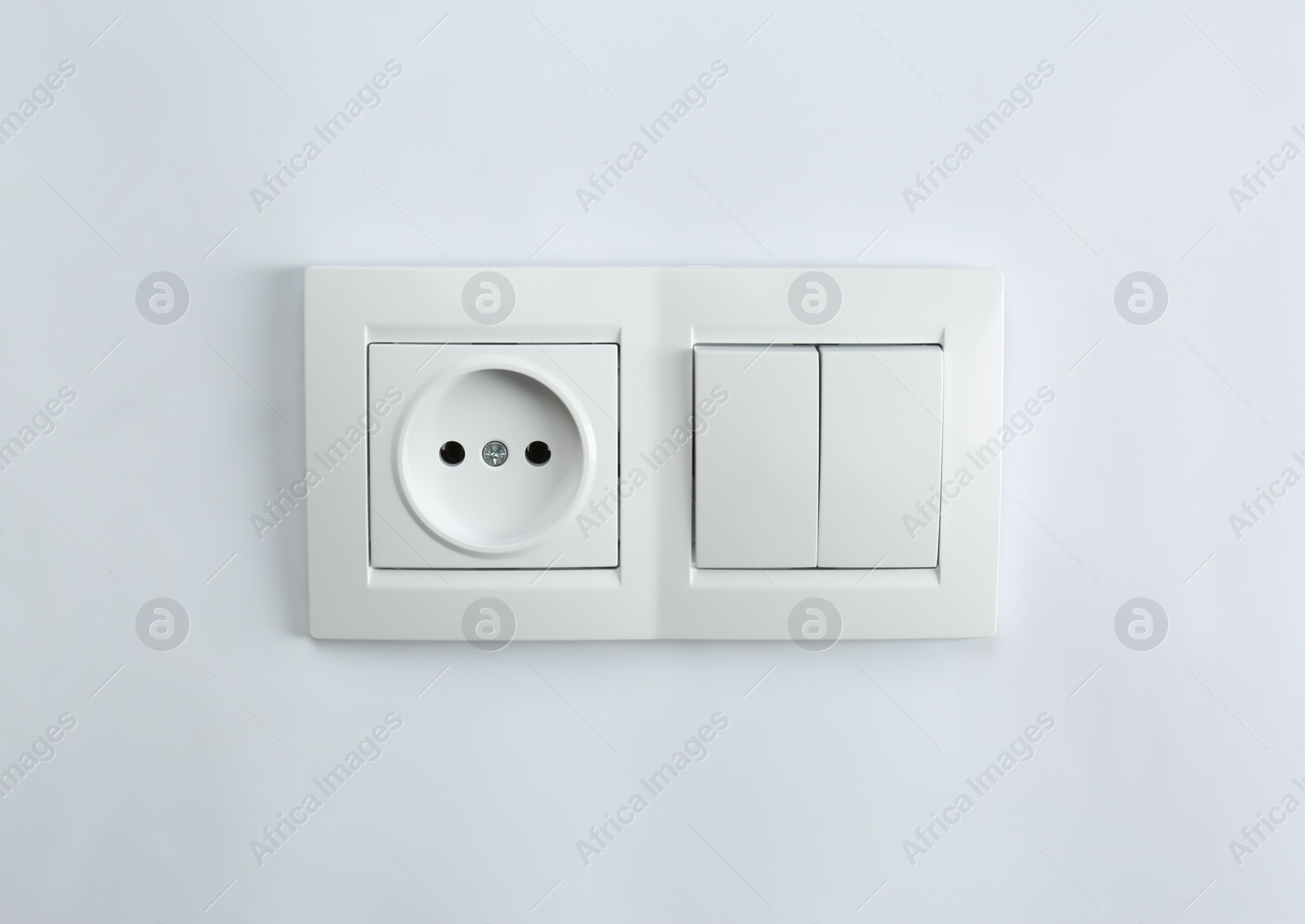 Photo of Light switch and power socket on white background. Electrician's equipment