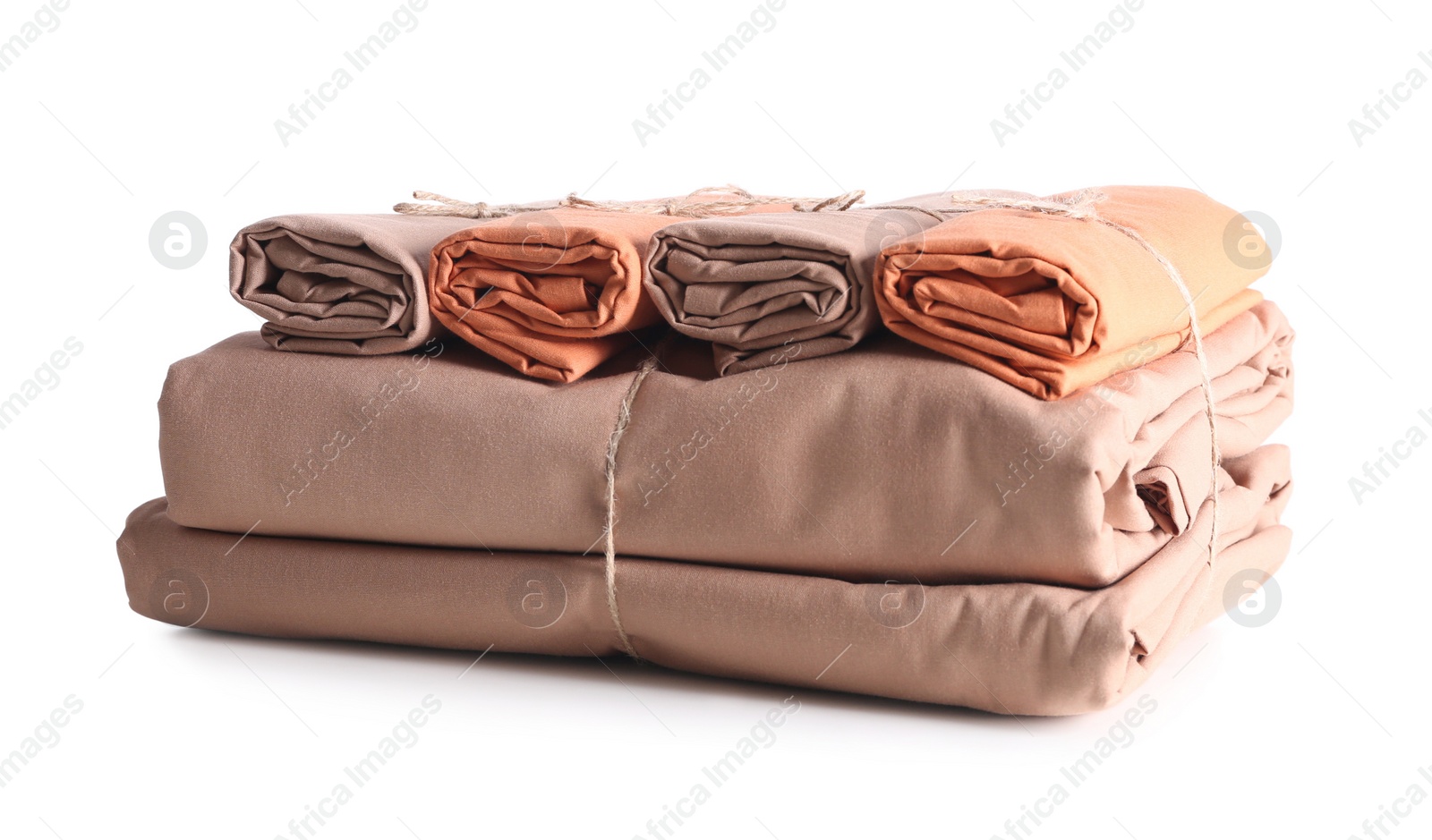Photo of Stack of clean bed sheets tied with rope isolated on white