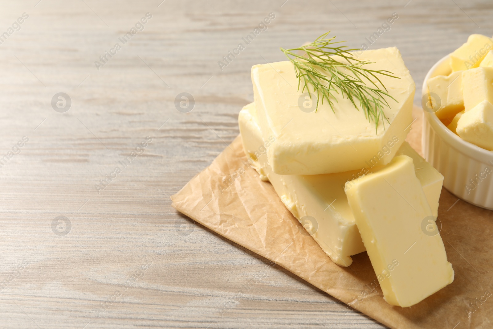 Photo of Tasty butter with dill on wooden table. Space for text