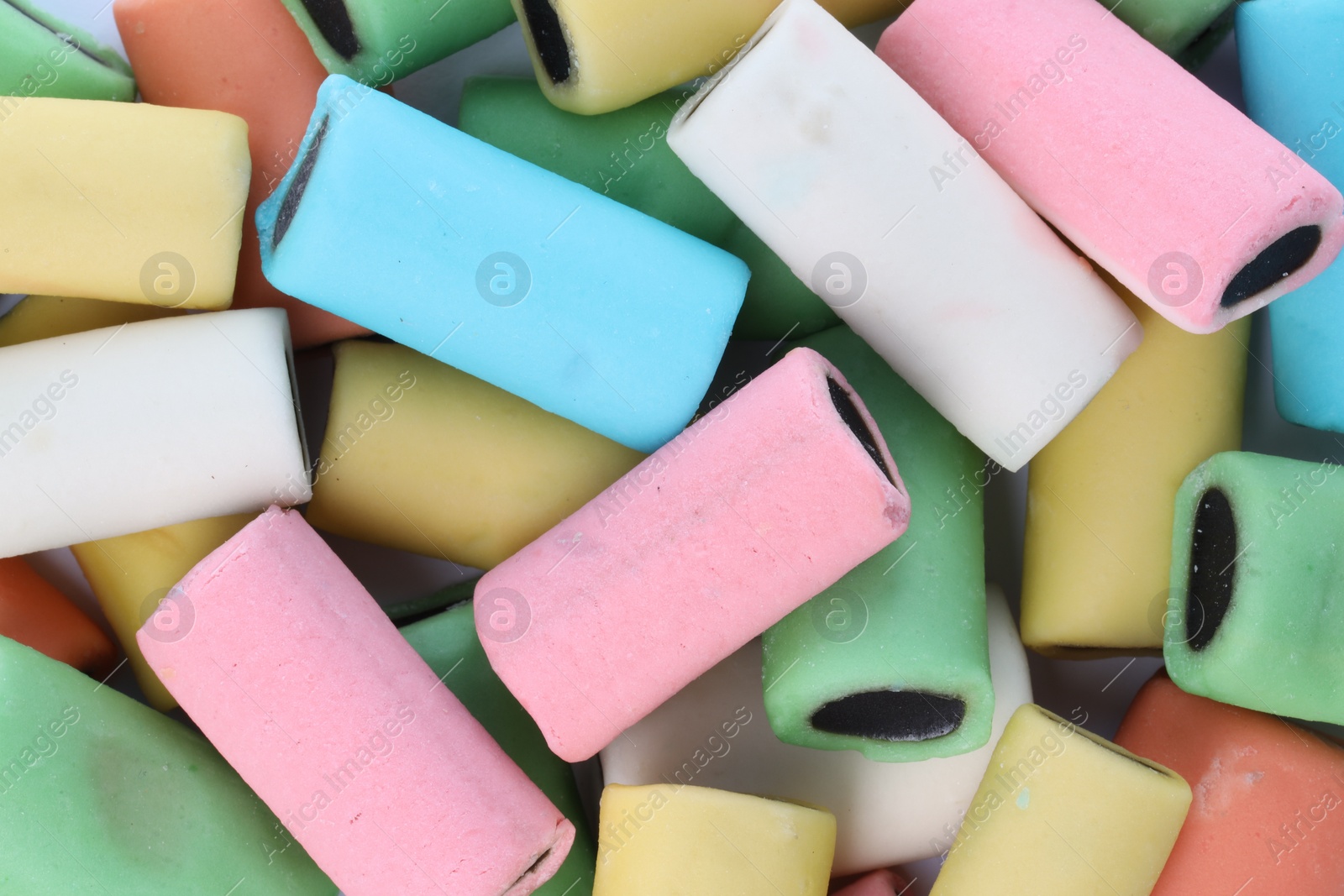 Photo of Many tasty liquorice candies on white background, top view