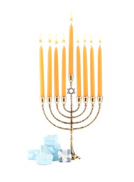 Photo of Hanukkah celebration. Menorah with candles and gift boxes isolated on white
