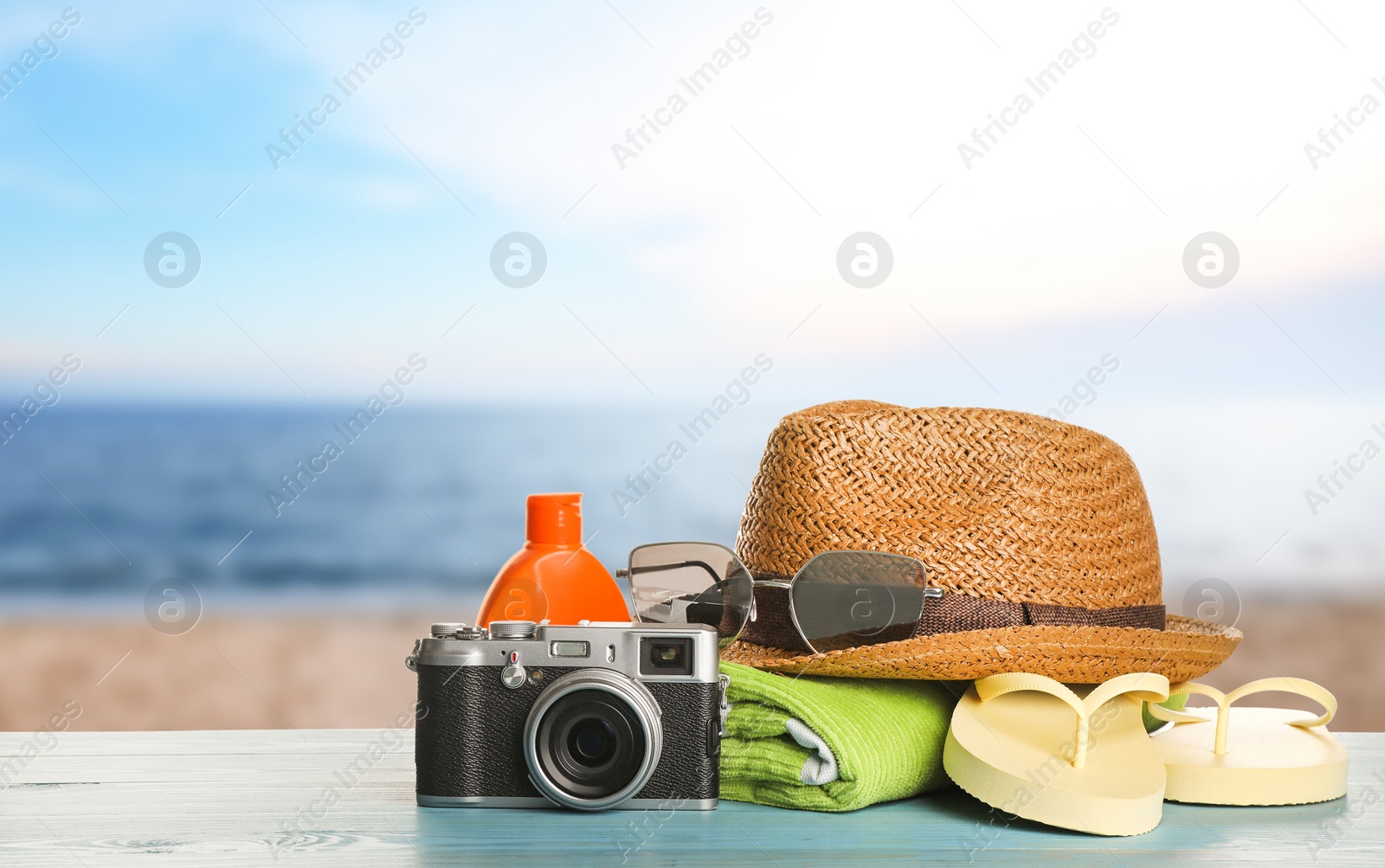 Image of Different beach objects on wooden surface near sea