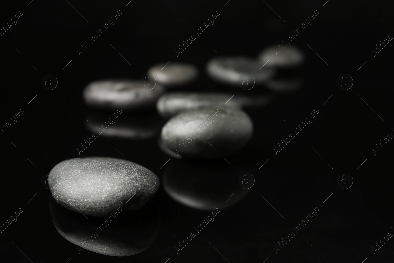 Photo of Spa stones on black background. Space for text