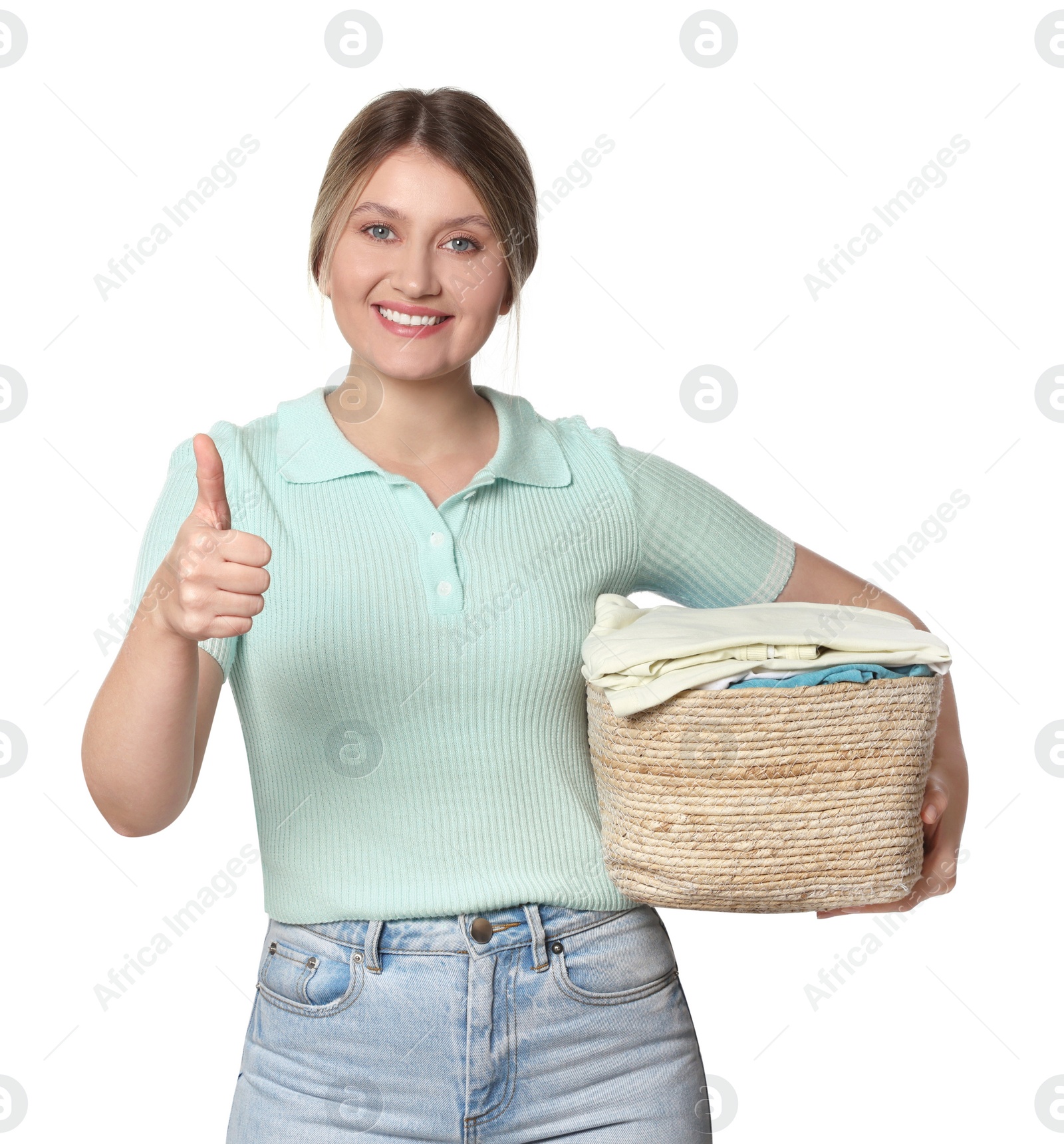 Photo of Happy woman with basket full of laundry showing thumb up on white background