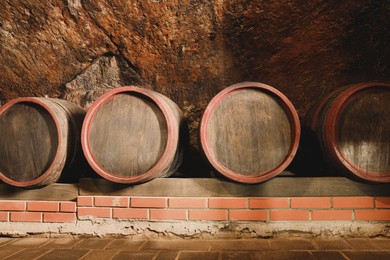 Many barrels of wine stored on shelf in cellar
