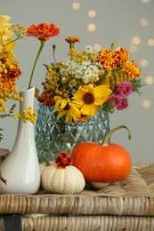 Photo of Beautiful autumn composition with pumpkins and flowers on wicker table