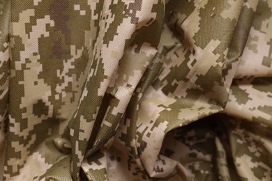 Photo of Texture of crumpled camouflage fabric as background, closeup