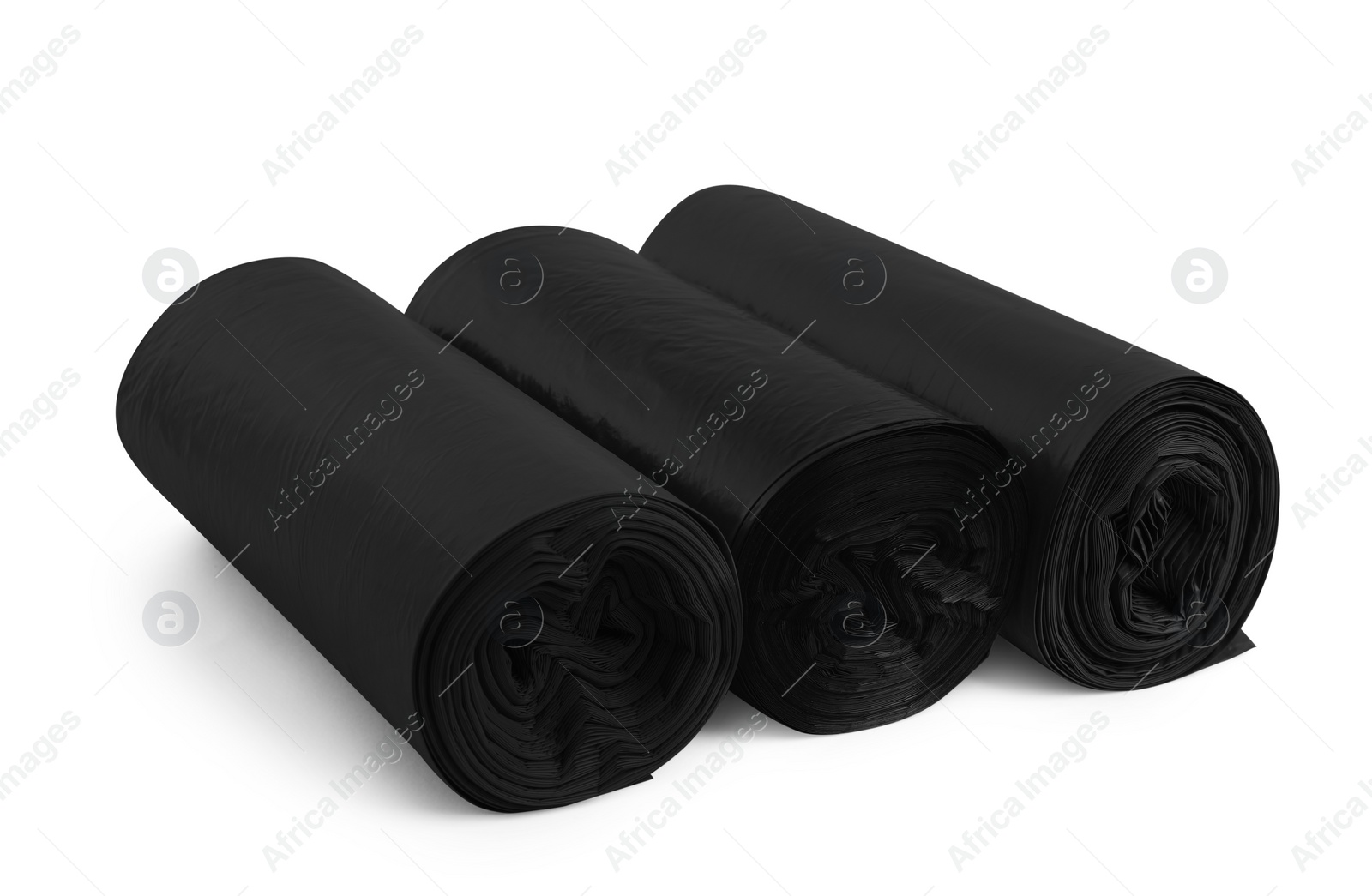 Photo of Rolls of different garbage bags on white background. Cleaning supplies