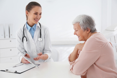 Photo of Senior woman visiting doctor in modern office