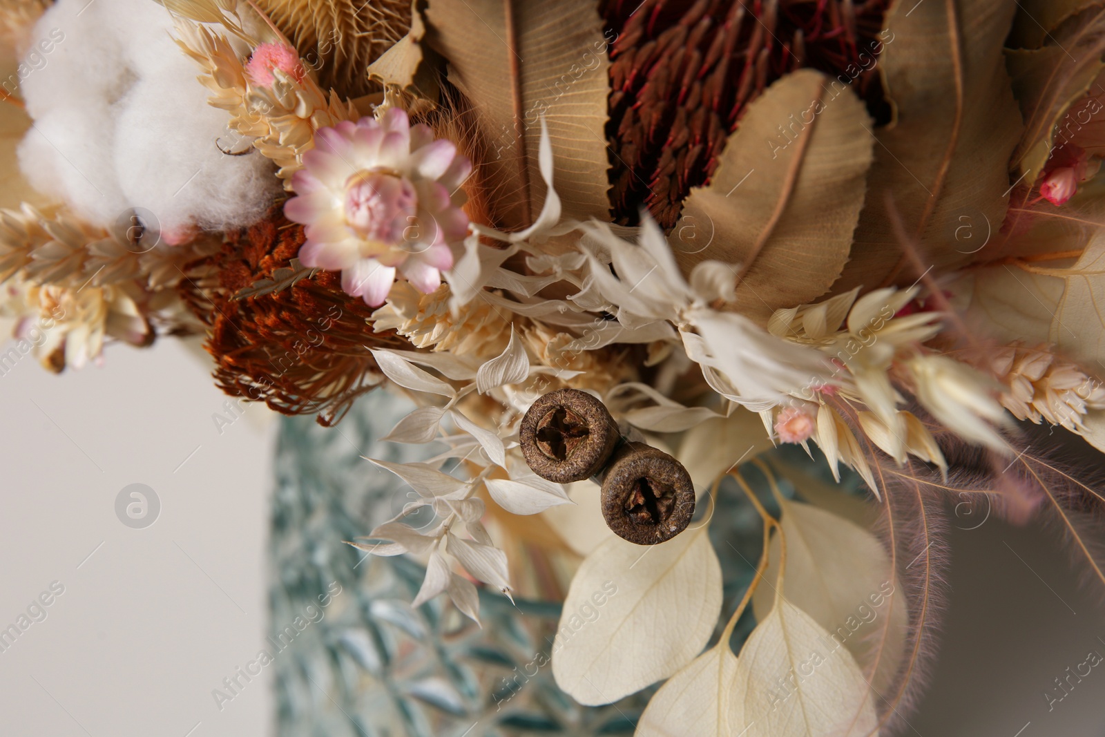 Photo of Beautiful dried flower bouquet in glass vase, closeup