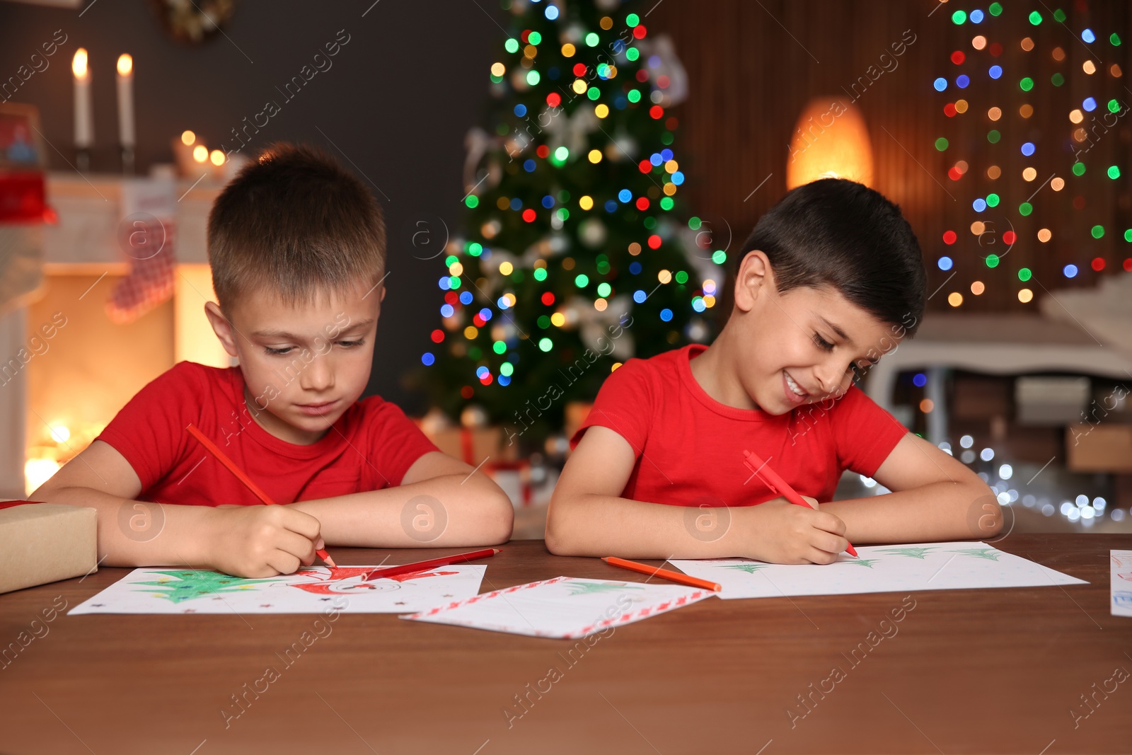 Photo of Little children drawing pictures at home. Christmas celebration