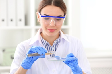 Photo of Female scientist working in laboratory. Research and analysis