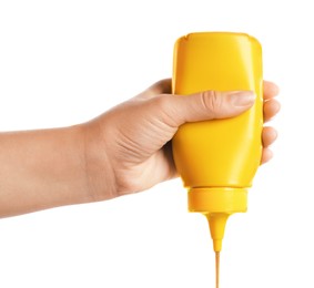 Woman with bottle of mustard on white background, closeup