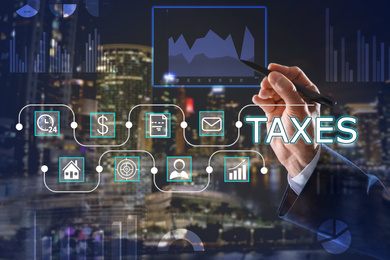 Image of Tax concept. Man using virtual screen, closeup