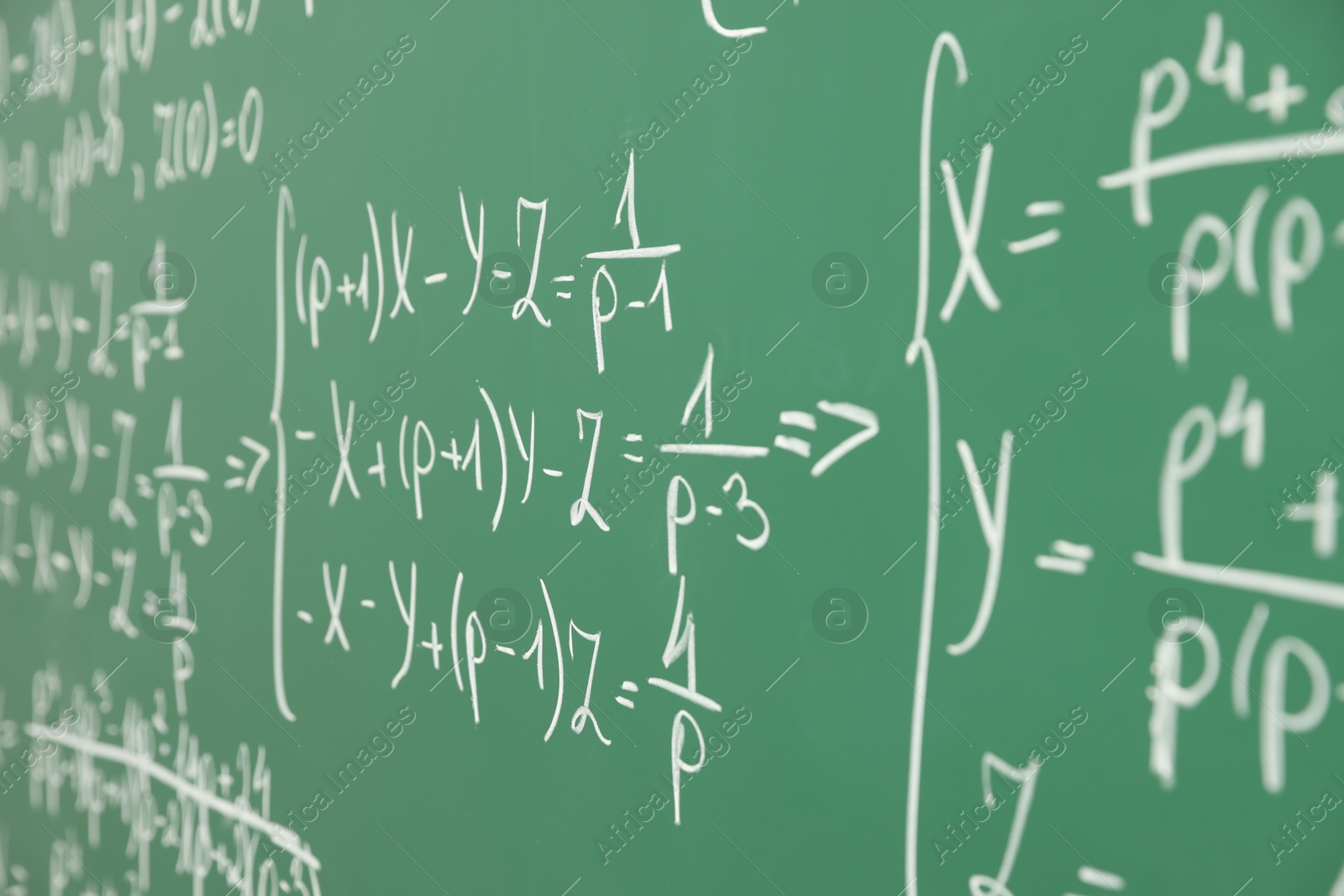 Photo of Many different math formulas written on chalkboard, closeup