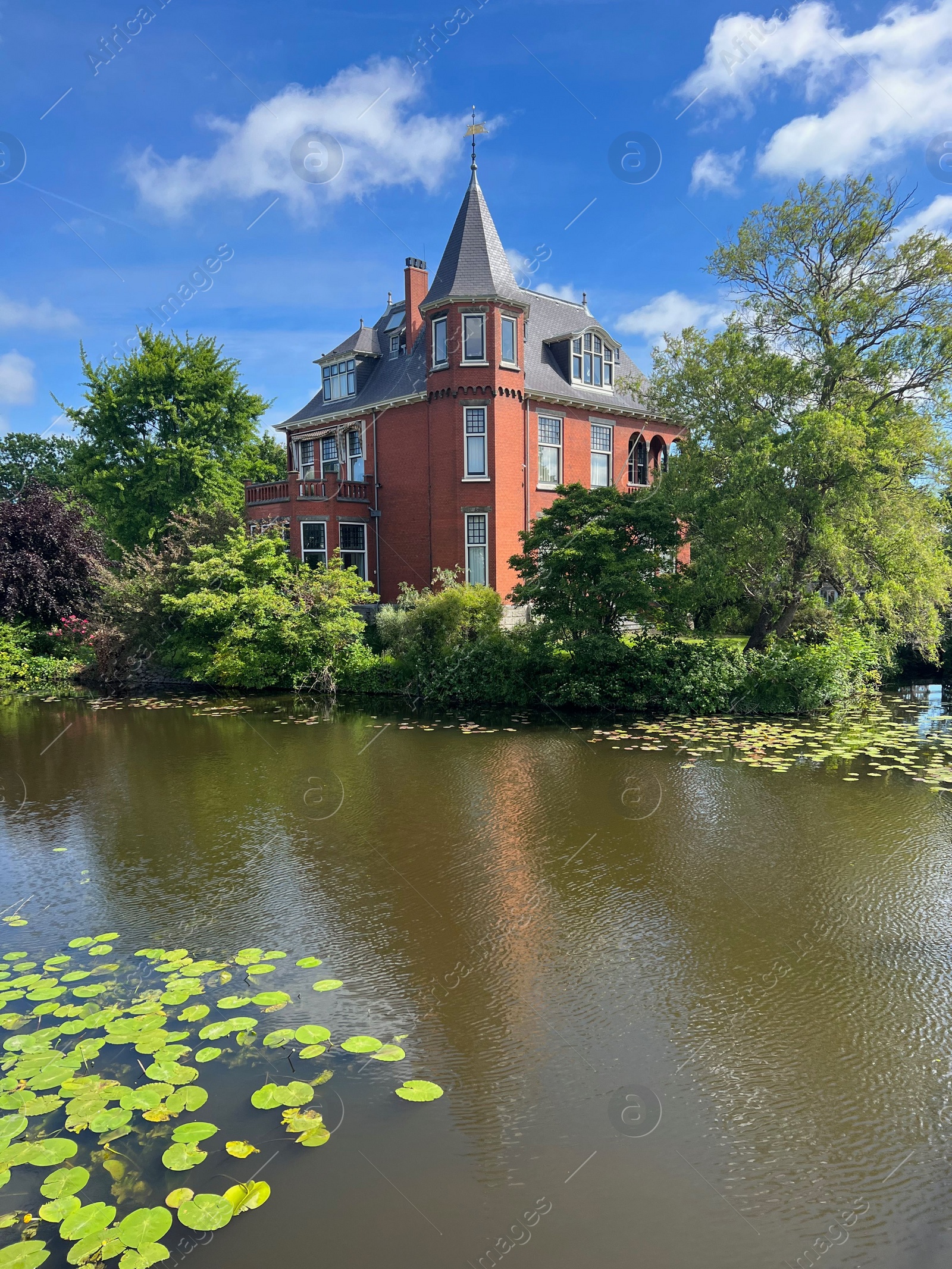 Photo of Beautiful view of house near river on sunny day