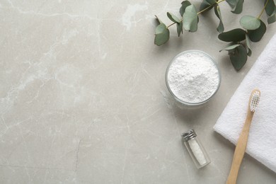 Photo of Flat lay composition with tooth powder and eucalyptus on light grey marble table, space for text