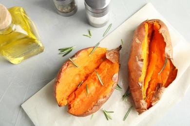 Flat lay composition with baked sweet potatoes on grey background