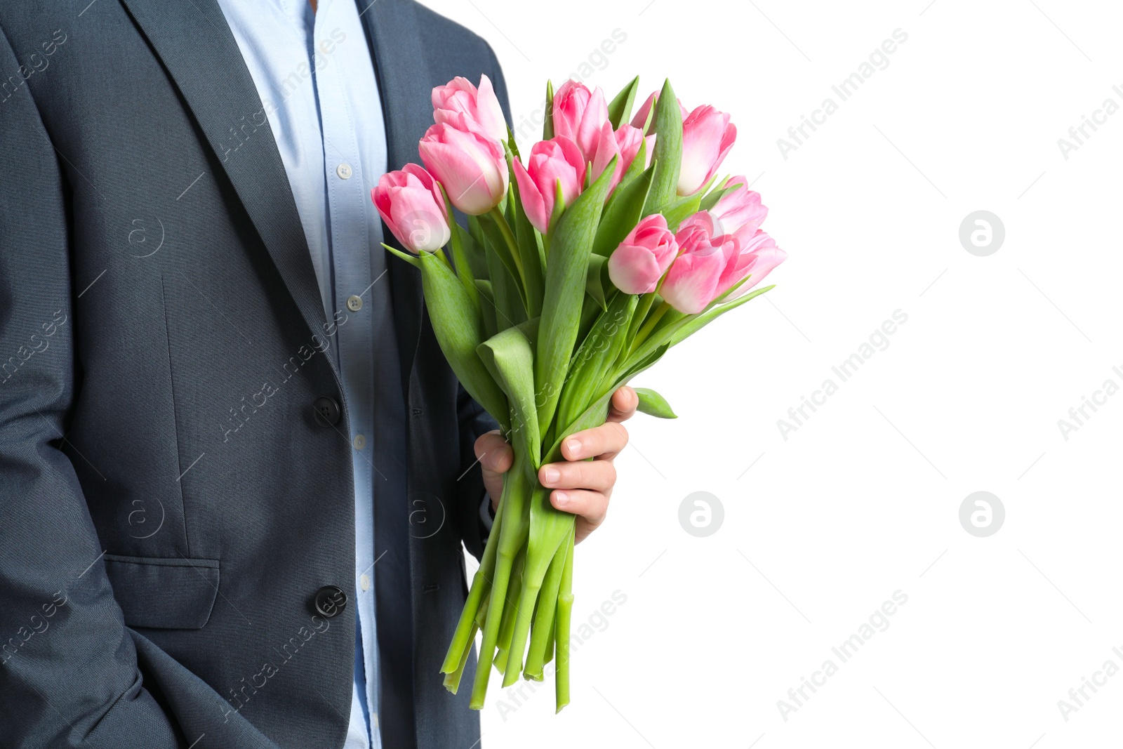 Photo of Man in elegant suit holding bouquet of beautiful spring tulips on light background, closeup. International Women's Day