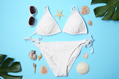 Photo of Flat lay composition with stylish bikini on color background