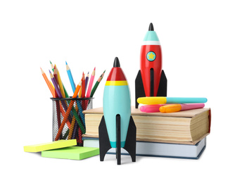 Bright toy rockets and school supplies on white background