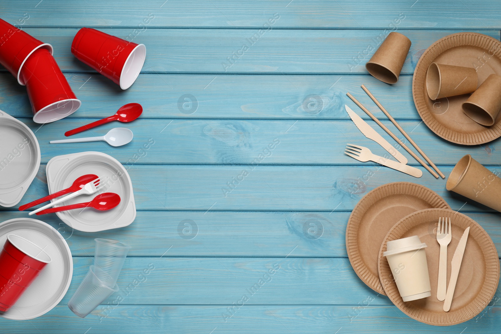 Photo of Flat lay composition with plastic and eco disposable tableware on light blue wooden background. Space for text