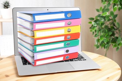 Image of Store and organize information. Hardcover office folders getting out of modern laptop