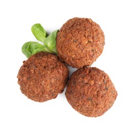 Photo of Delicious falafel balls and lambs lettuce on white background, top view. Vegan meat products