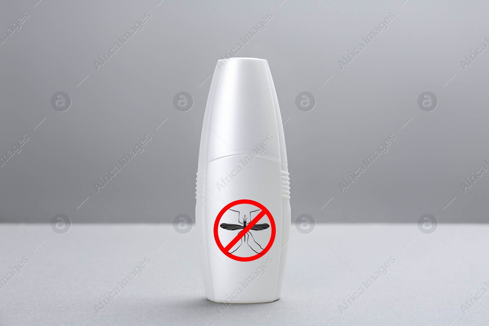 Image of Bottle of insect repellent on grey background