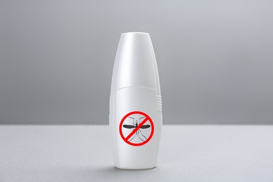 Image of Bottle of insect repellent on grey background