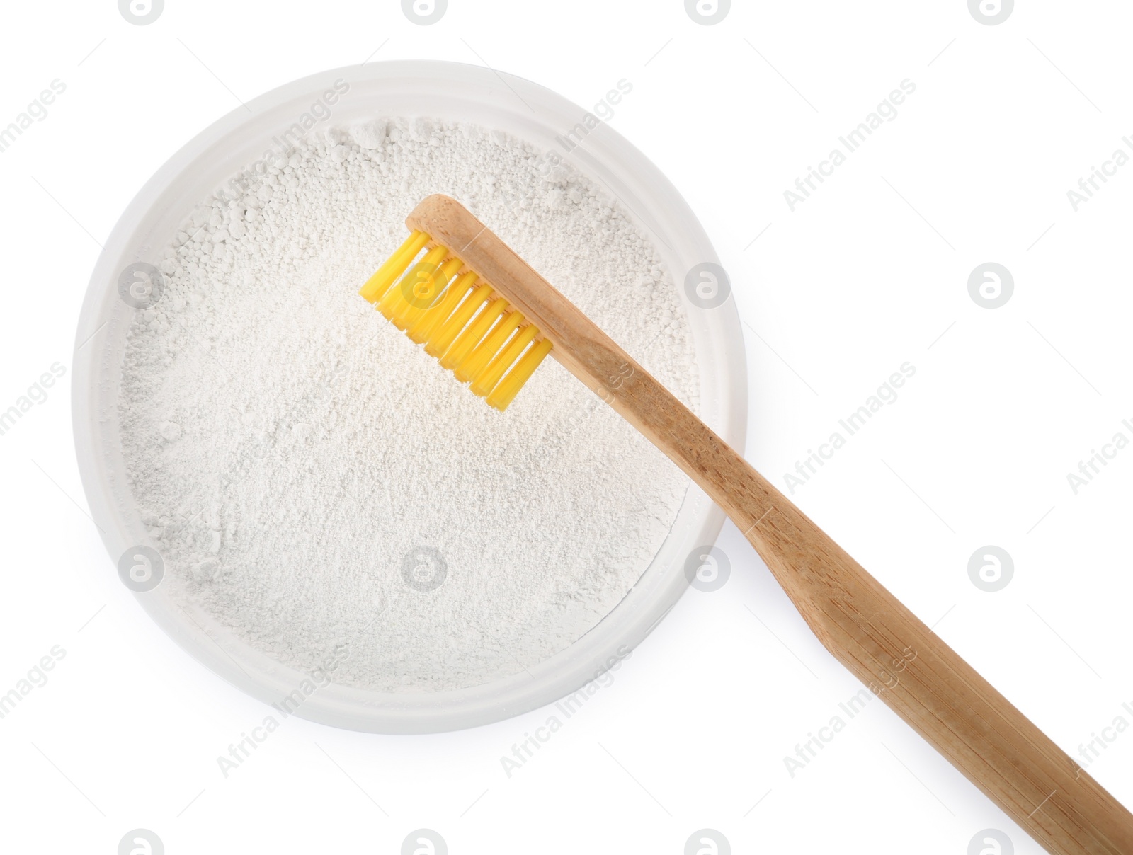 Photo of Bowl of tooth powder and brush on white background, top view