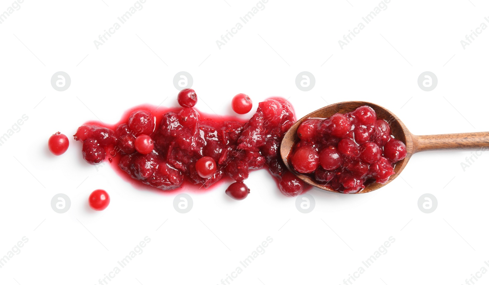 Photo of Spoon with spilled cranberry sauce on white background, top view