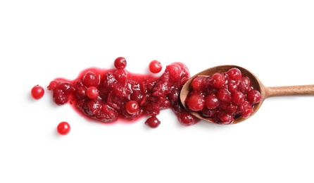 Photo of Spoon with spilled cranberry sauce on white background, top view