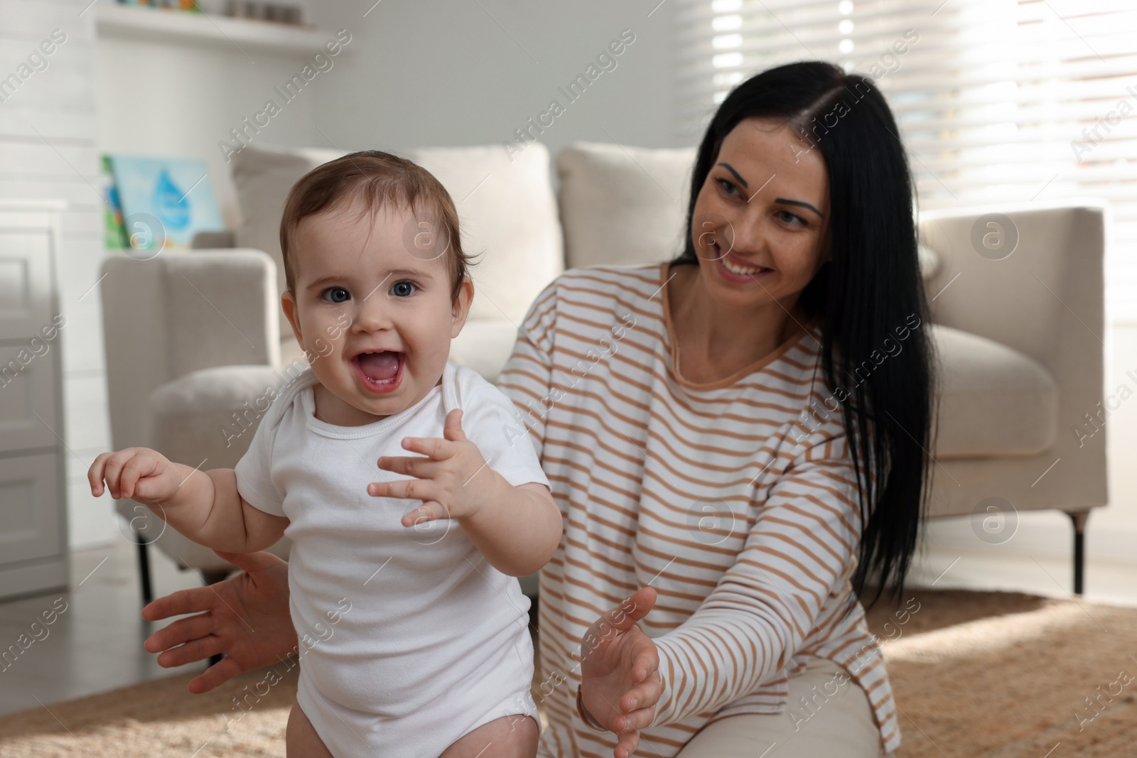 Photo of Happy mother with her cute baby at home