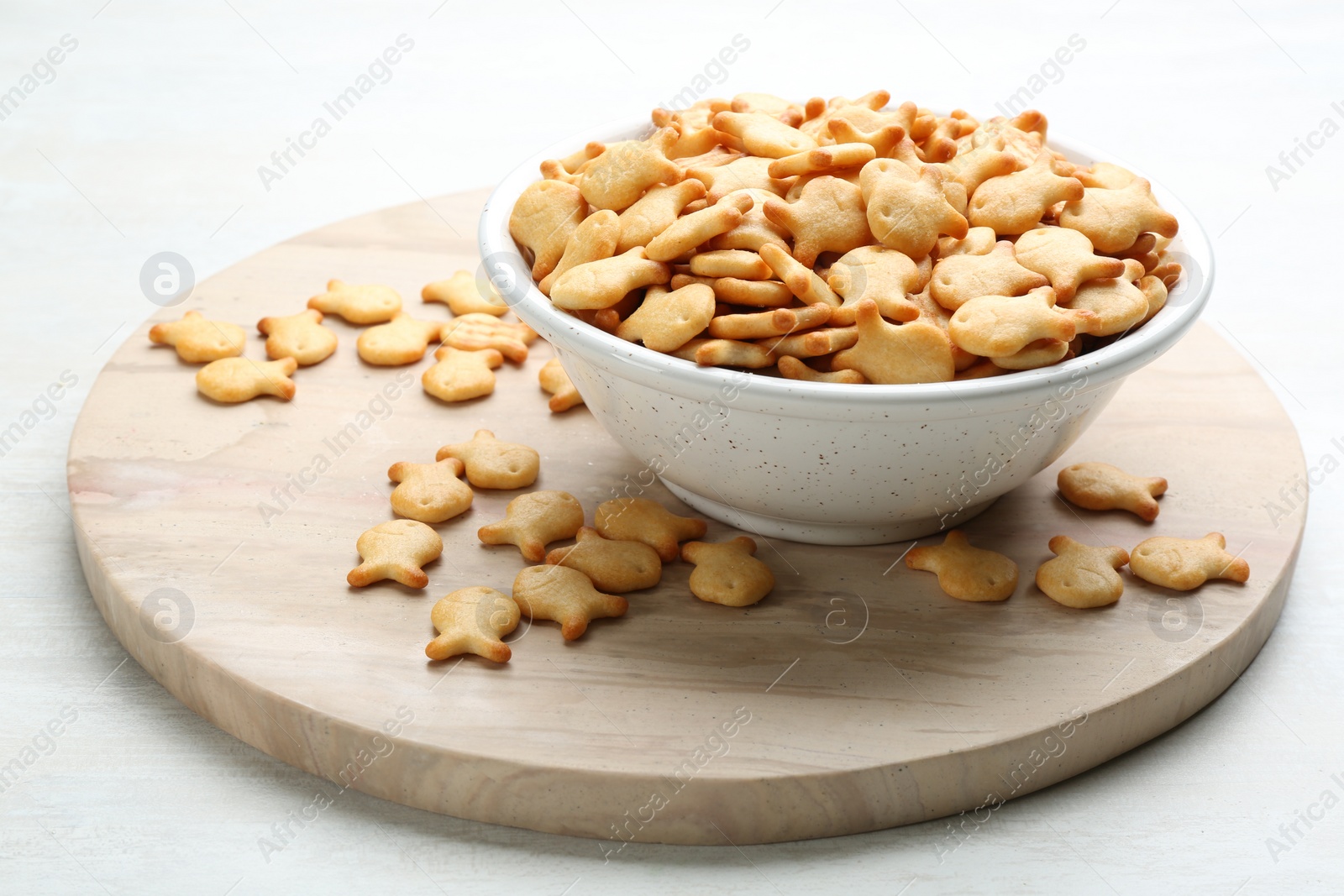 Photo of Delicious goldfish crackers in bowl on table