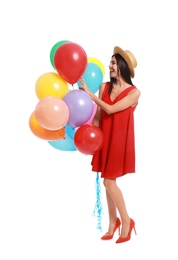 Young woman holding bunch of colorful balloons on white background