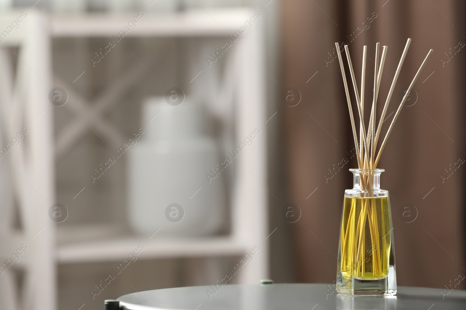 Photo of Reed air freshener on table indoors, space for text