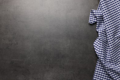 Photo of Checkered tablecloth on grey background, top view. Space for text