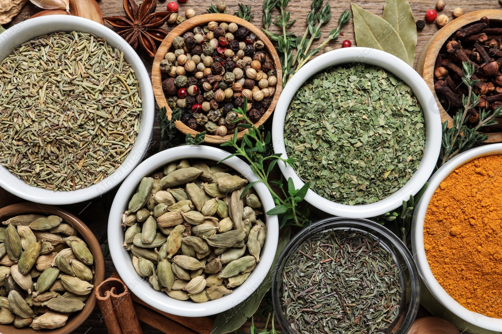 Photo of Flat lay composition with different natural spices and herbs on wooden table