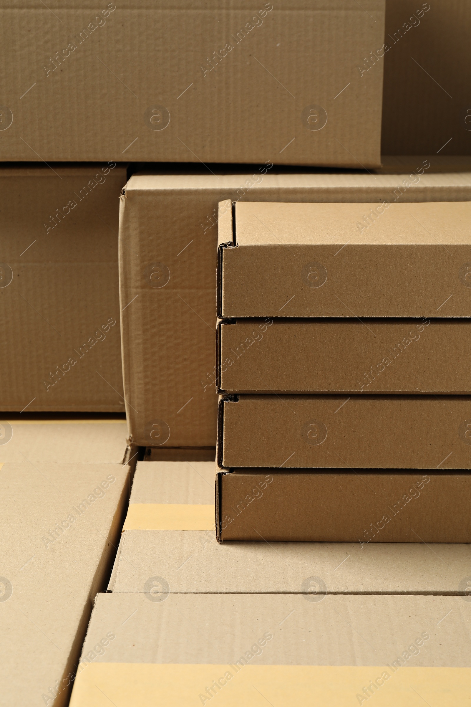 Photo of Many cardboard boxes as background, closeup. Packaging goods