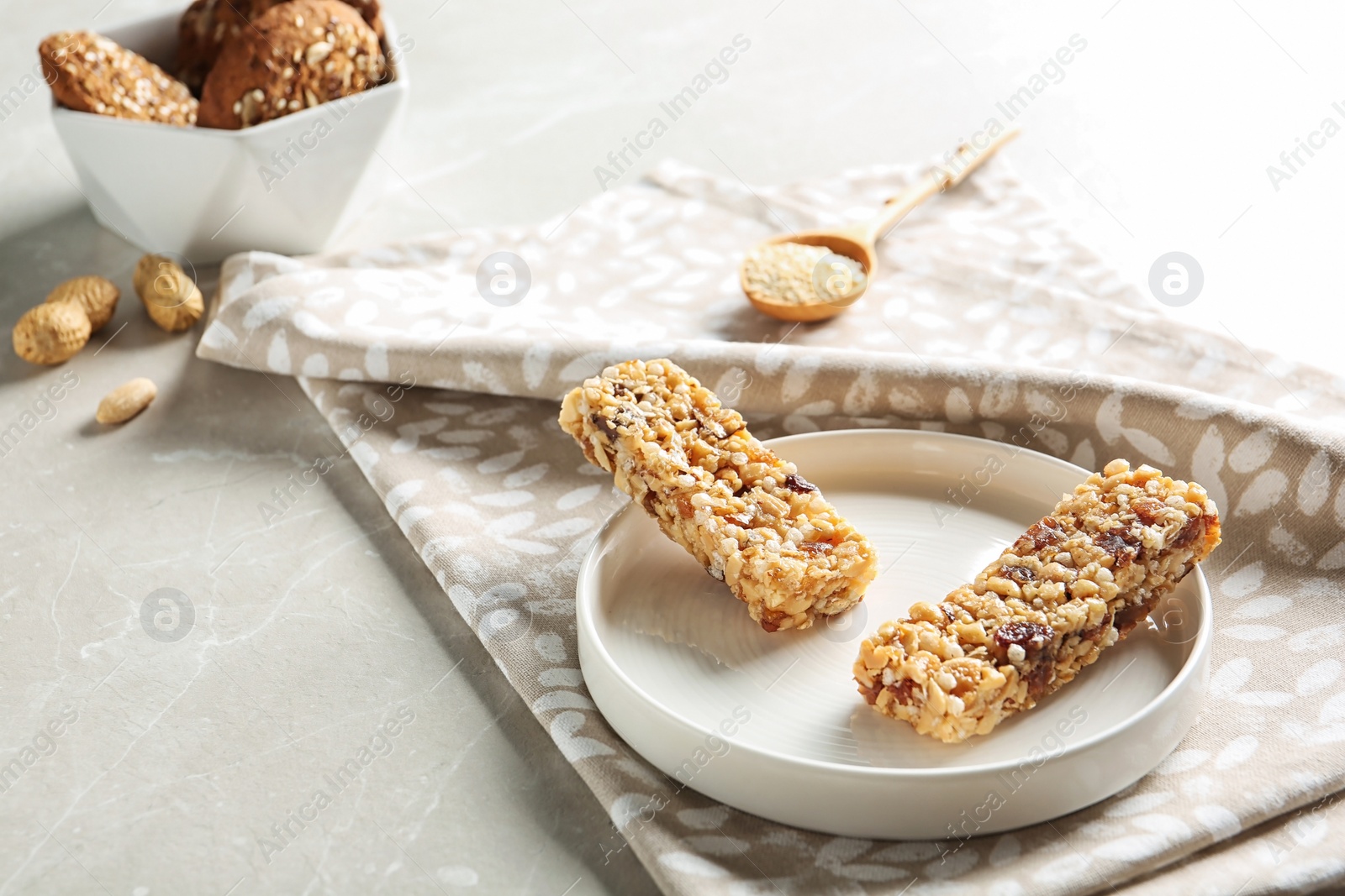 Photo of Plate with different homemade grain cereal bars on table. Healthy snack