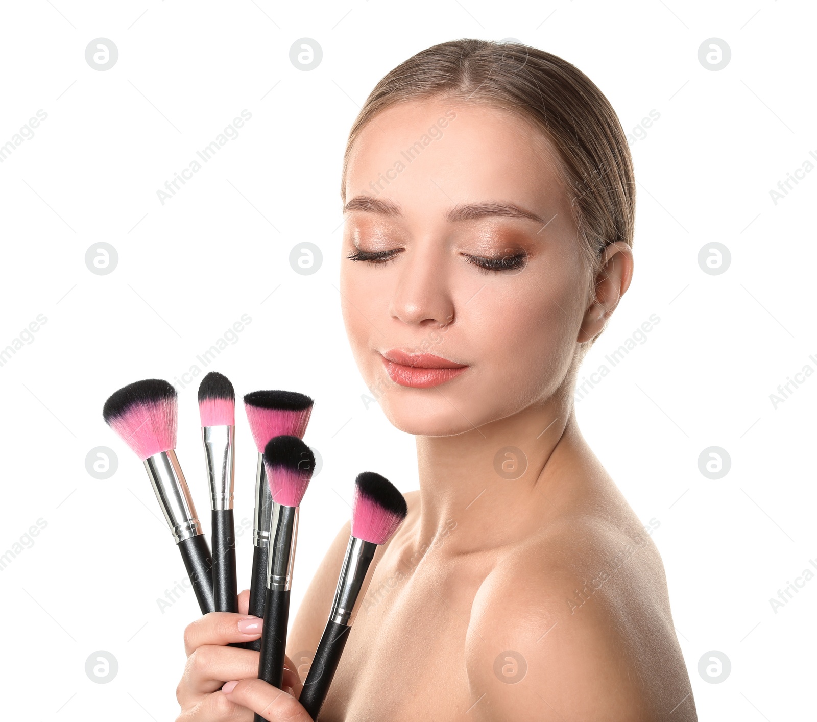 Photo of Portrait of beautiful young woman with makeup brushes on white background