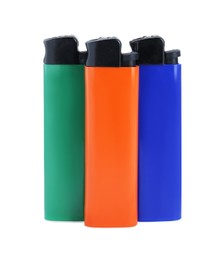 Photo of Stylish small pocket lighters on white background