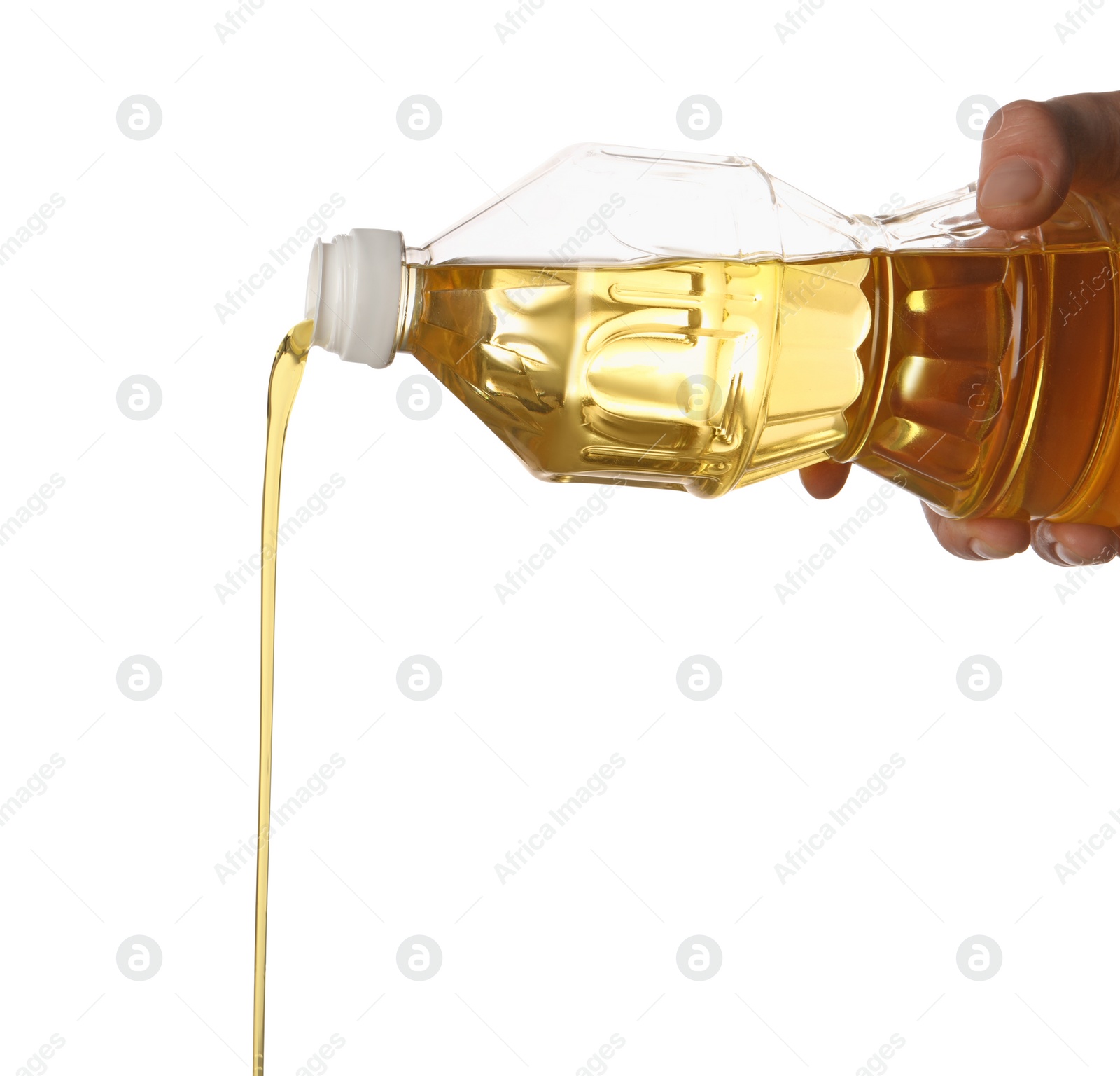 Photo of Pouring cooking oil from bottle on white background